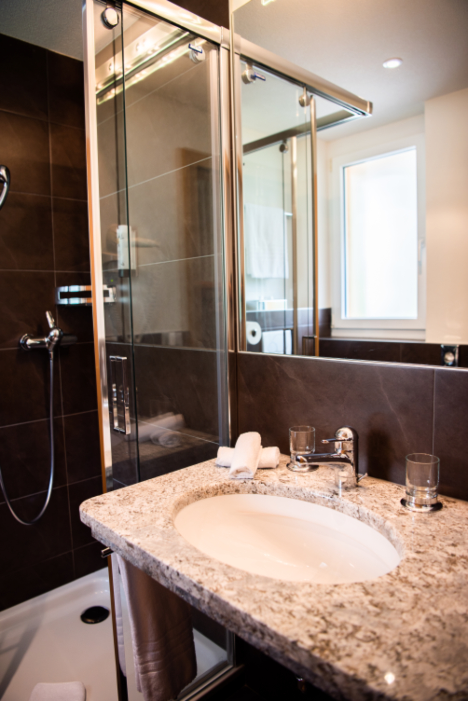 Finished bathroom with granite vanity following a domestic installation