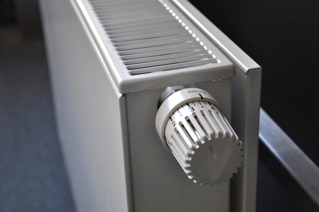 Panel radiator and thermostat in a commissioned commercial heating system