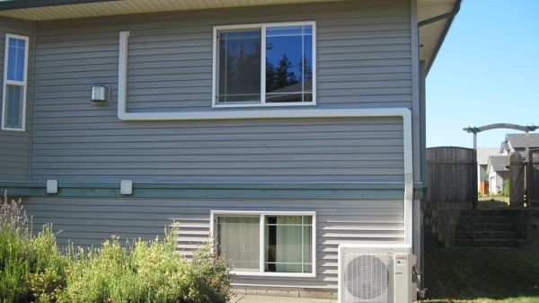 Air source heat pump unit installed on the exterior of a house