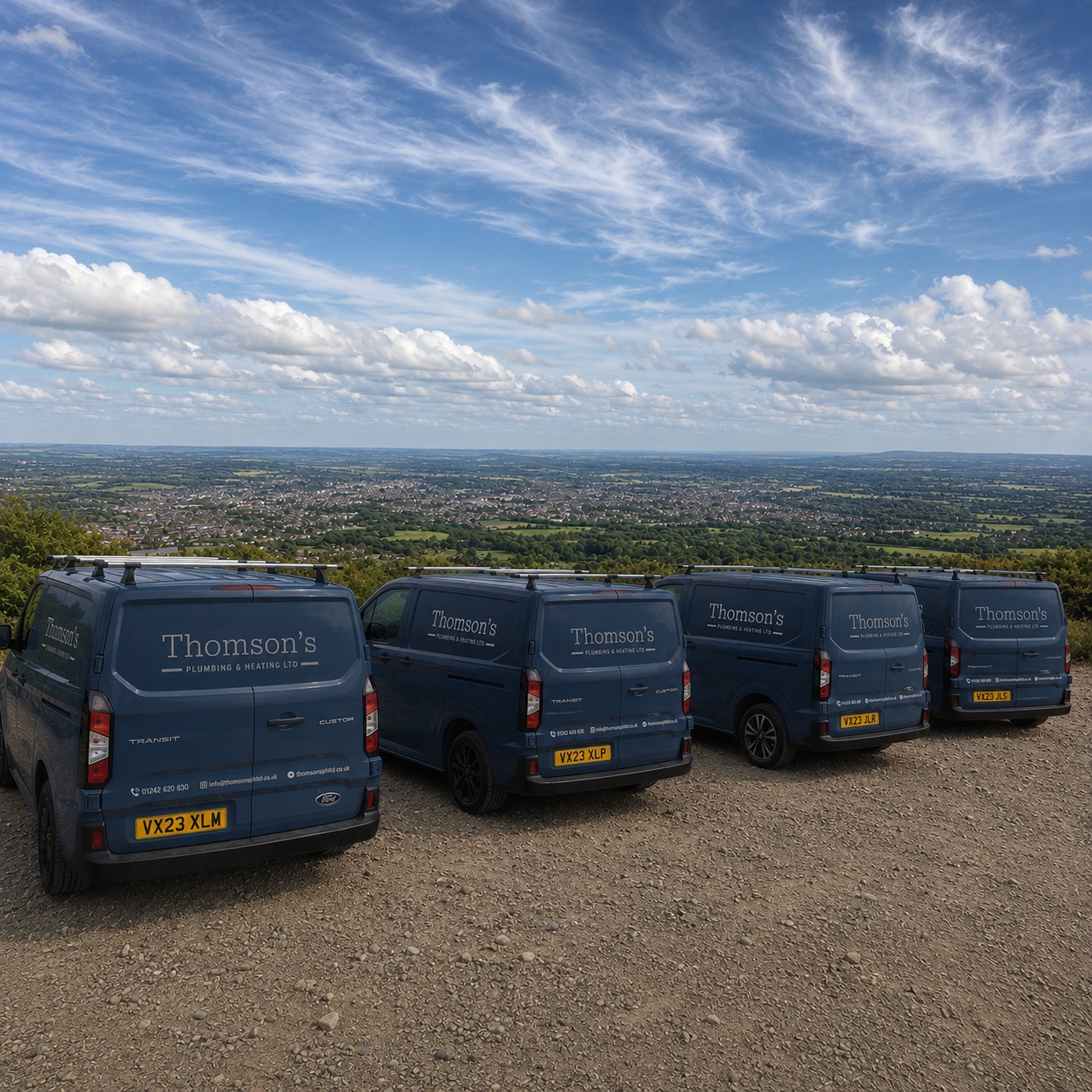 The Thomson's Plumbing & Heating van fleet lined up on a Cotswold hilltop above Cheltenham
